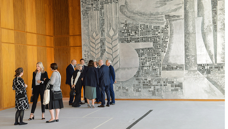 people in front of the aluminium relief in the sitzungsaal