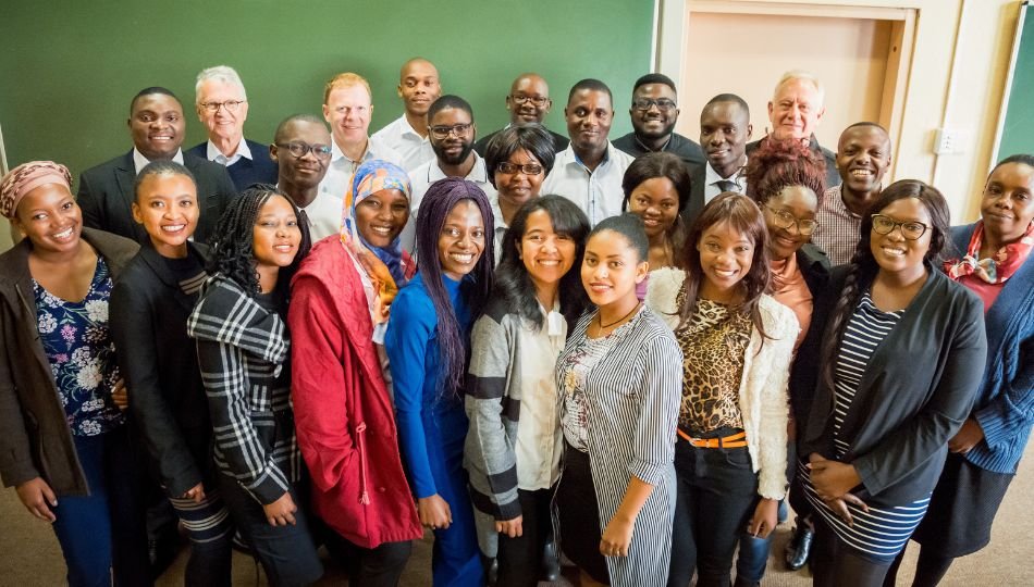 African students posing for group photo with professors